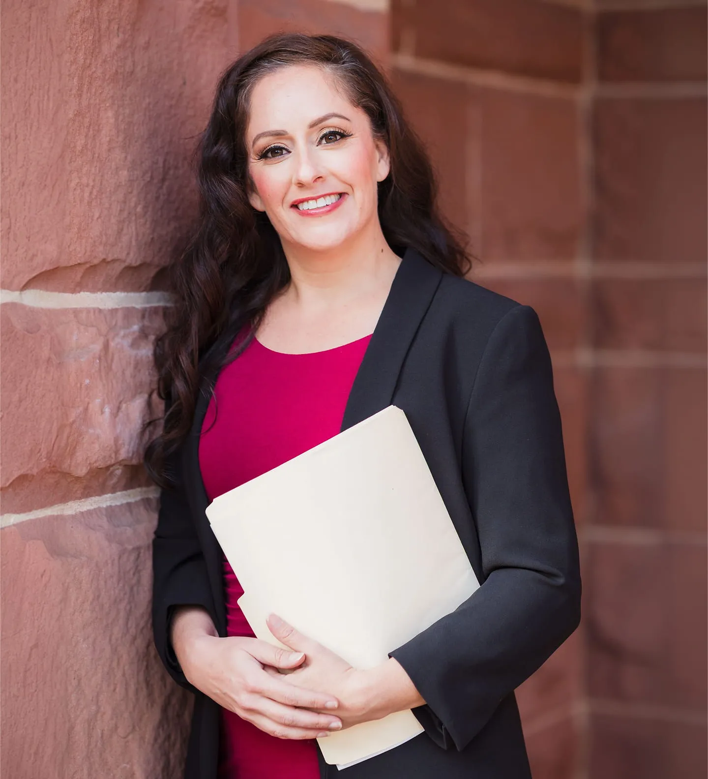 Giselle Rodriguez attorney portrait holding legal file outside Law Office of Giselle Rodriguez, PC